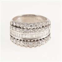 Lot 257 - A diamond five band dress ring, the 18 carat all white gold mount set with forty-four brilliant cut diamonds and nineteen baguette cut diamonds