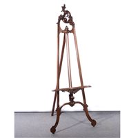 Lot 542 - Carved walnut easel, rococo style scroll decoration, heigh 185cm.