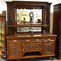 Lot 509 - Victorian carved walnut mirror-back sideboard, bevelled glass plates and the pilaster canopy, the base fitted with three frieze drawers and cupboards below, , width 183cm, , height 245cm.