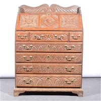 Lot 462 - Victorian carved oak bureau, fall front enclosing fitted interior, with central cupboard, drawers and pigeon holes, three short and three long drawers under, width 84cm.