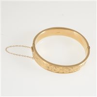 Lot 287 - A 9 carat yellow gold hollow half hinged bangle, 11.5mm wide flat section with engraved pattern to front, hallmarked Birmingham 1961, approximate weight 17gms.