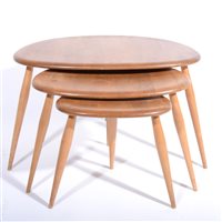 Lot 613 - A nest of three elm and beech 'Pebble' tables by Ercol