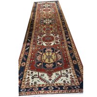 Lot 545 - Heriz runner, wth seven medallions on a red field, border within guards, 480cm x 128cm.