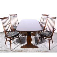 Lot 374 - Ercol dark elm dining room suite