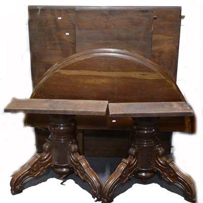 Lot 421 - A walnut and stained wood extending dining table
