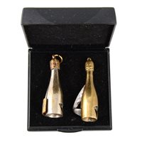 Lot 186 - Two novelty cigarette cutters in the form of champagne bottles