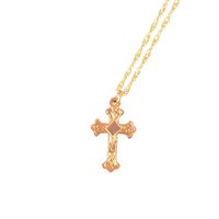 Lot 266 - A rose metal cross, 25mm, marked 9ct on a modern 9 carat yellow gold twisted flat curb link chain 40cm long, total weight approximately 4.5gms.