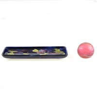 Lot 21 - A Moorcroft Pottery pin dish, Clematis design, circa 1950; and an Okra Studio paperweight.