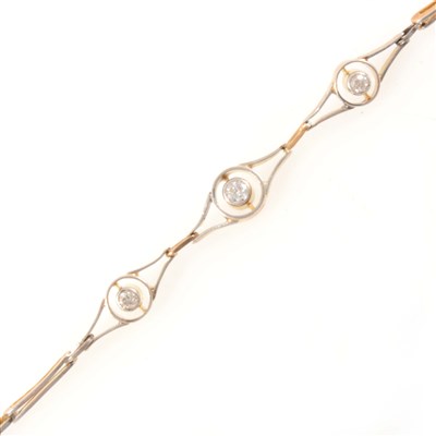 Lot 349 - A yellow and white metal bracelet set with three diamonds.