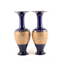 Lot 24 - Pair of Royal Doulton Slater's patent vases, blue ground with a broad mottled floral band, No. 7009, 35cm.