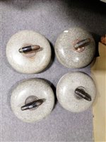 Lot 101A - Four Scottish granite curling stones, metal and ebony handles, two having a white metal shield engraved "JM" two marked "AM" on the stones, overall diameter 27cm.
