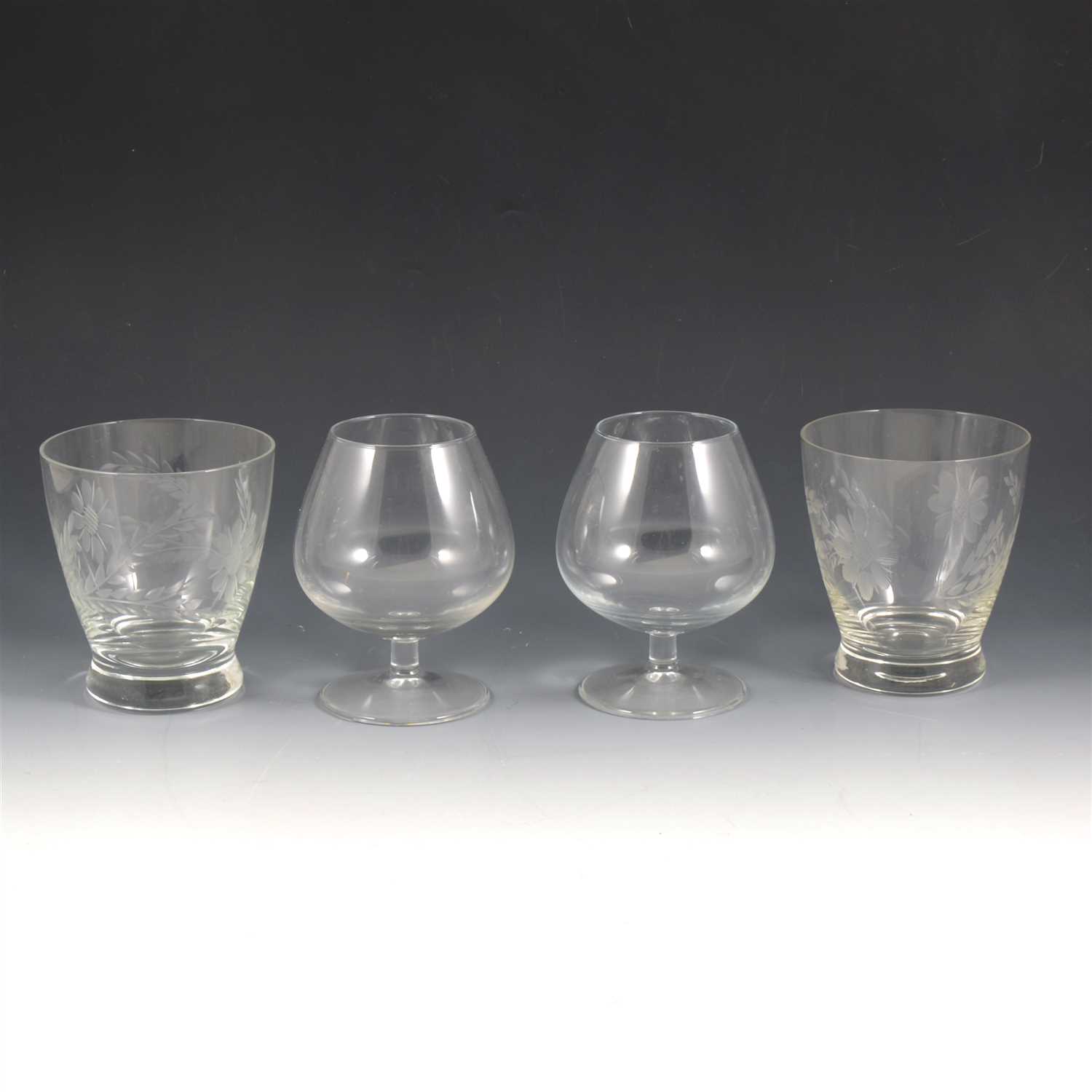 Lot 57 - A quantity of etched and cut table glass, to include eight etched glass rinsers, a jug and set of six grape and vine etched squat goblets, six heavy goblets, six brandy balloons, six sherry glasses