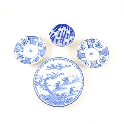 Lot 52 - A collection of Japanese blue and white plates and dishes, to include two with dragon design to centre, 21.8cm diameter, and a set of three with floral design, 14.8cm.