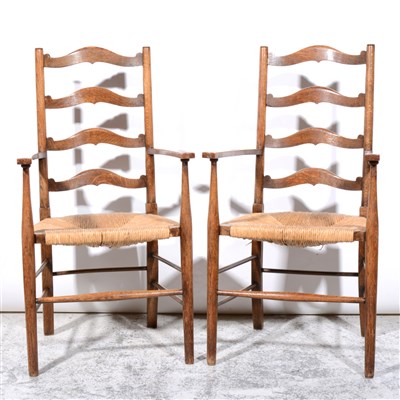 Lot 356 - Two Arts and Crafts oak framed ladder back armchairs, in the manner of Ernest Gimson
