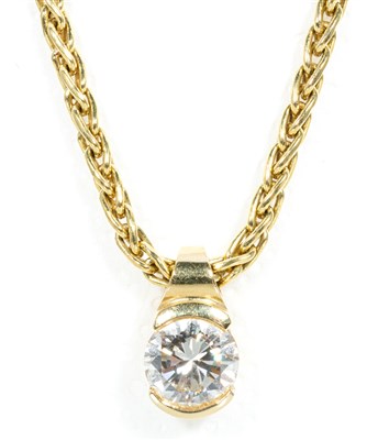 Lot 214 - A diamond solitaire pendant and chain.