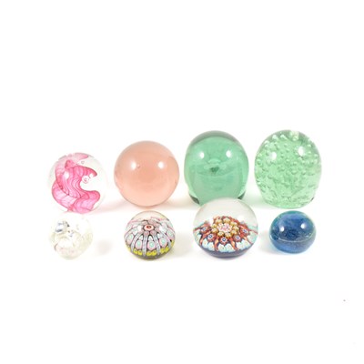 Lot 19 - A green glass dumpy paperweight with bubble inclusion, and eight others.