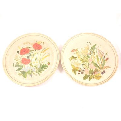 Lot 75 - A pair of buff coloured circular plaques, P. Ipsen, each painted with spring flowers, diameter 37cm.