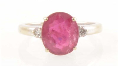 Lot 203 - A ruby and diamond three stone ring, an oval mixed cut ruby