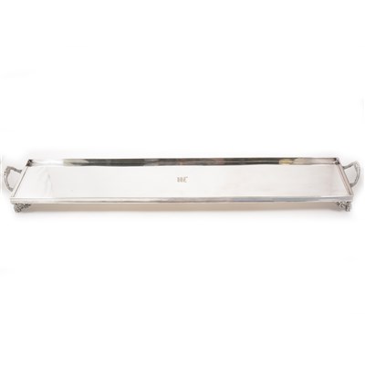 Lot 95 - An Edwardian plated kettle on stand, shaped oval section, with burner, 32cm, and a rectangular tray, engraved initial M, raised on regency pattern lion paw feet, length 83cm.