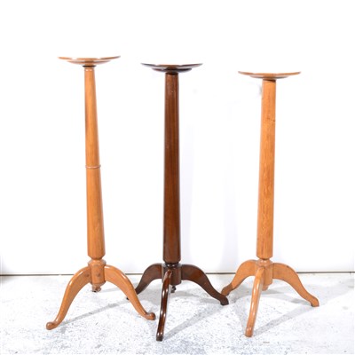 Lot 315 - A mahogany torchere, and two oak torcheres
