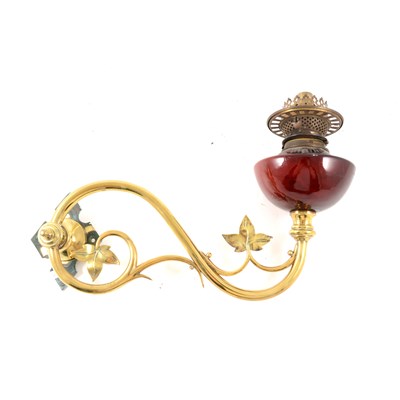 Lot 100 - An Edwardian brass wall mounted oil lamp