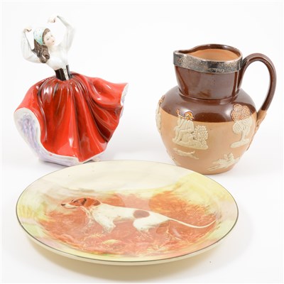 Lot 36 - Royal Doulton stoneware jug, with a silver rim; three Royal Doulton Series Ware wall plates.; Doulton figure, Karen