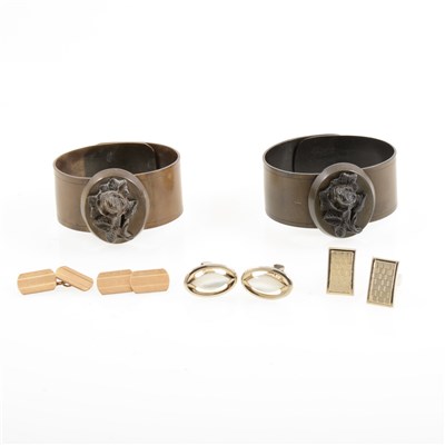 Lot 260 - Two vintage expanding bangles with oval moulded floral motifs, f