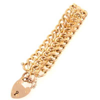 Lot 249 - A yellow metal bracelet with padlock fastener.