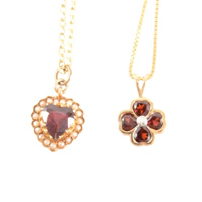 Lot 313 - Two garnet pendants on chains.