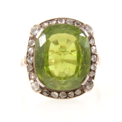 Lot 209 - A peridot and diamond cluster ring.