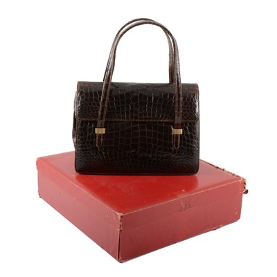 Lot 277 - Cartier - a vintage patent crocodile finish handbag.