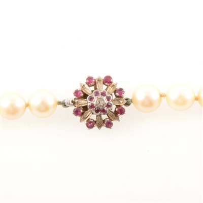 Lot 233 - A cultured pearl necklace with ruby fastener.