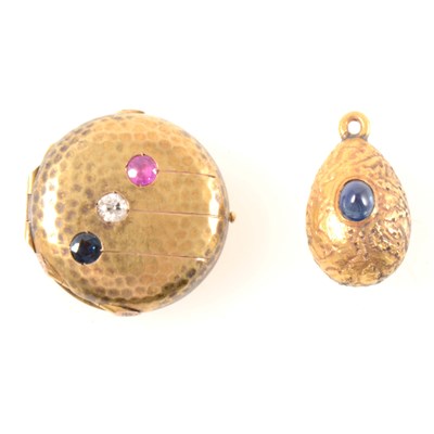 Lot 266 - A yellow metal circular locket and egg pendant.