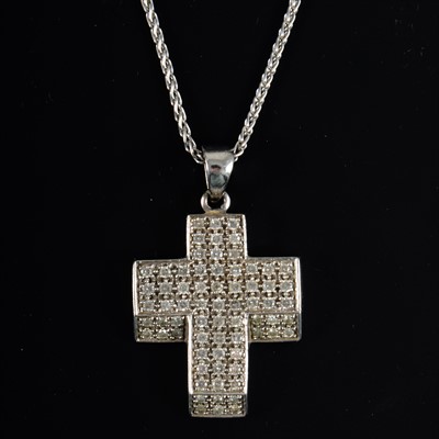 Lot 686 - A diamond set cross and chain.