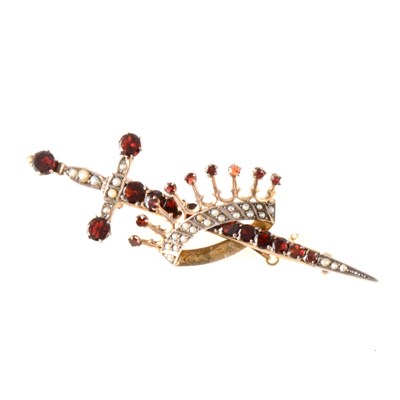 Lot 370 - A sword and crown brooch set with garnets and seed pearls.