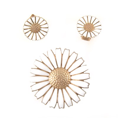 Lot 389 - Georg Jensen - a silver gilt and white enamel daisy brooch and matching earclips.