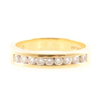 Lot 251 - A diamond half eternity ring.
