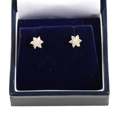 Lot 299 - A pair of diamond cluster earrings.