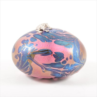 Lot 311 - A 'Dinosaur Egg' iridescent glass paperweight with silver frog, by John Ditchfield for Glasform.