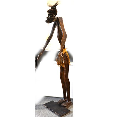Lot 146 - A primitive carved wood figure, a man standing...