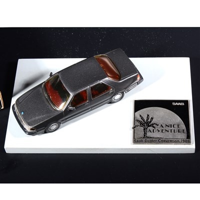 Lot 301 - A Somerville white metal model Saab 9000 CD 1988, a promotional desk piece made for the Saab Dealer Convention 1988, mounted on wooden base with logo plague, 16cm by 9cm base, boxed.