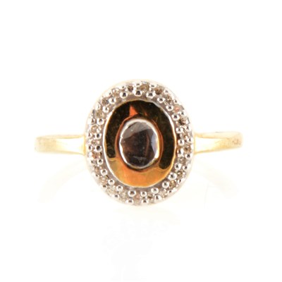 Lot 150 - An oval diamond cluster ring with rough diamond to centre.