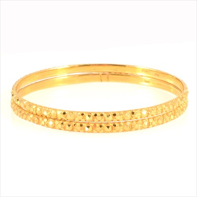 Lot 693 - Two 22 carat yellow gold slave bangles.