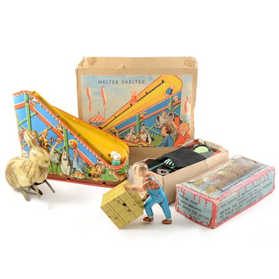 Lot 119 - Four tin-plate wind-up toys, including Helter Skelter, Coffin Bank and others.