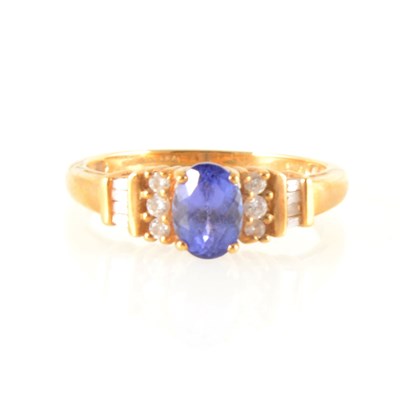 Lot 155 - An oval tanzanite and diamond ring