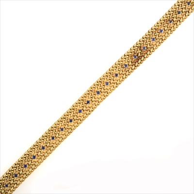 Lot 691 - A yellow metal bracelet set with sapphires.