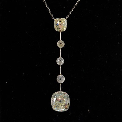 Lot 684 - A diamond set drop pendant with two antique cushion cut diamonds and three old cut diamonds.