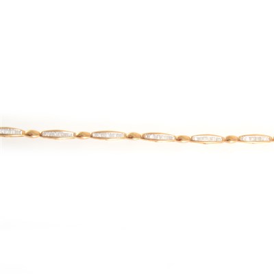 Lot 171 - An 18 carat yellow and white gold diamond line bracelet.