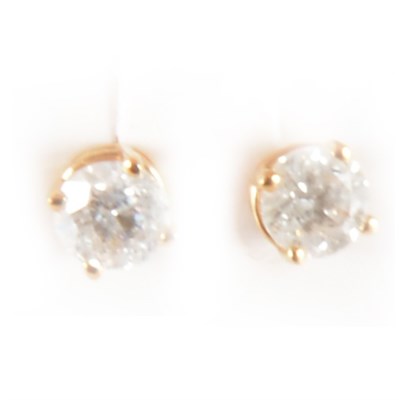 Lot 163 - A pair of diamond solitaire earrings.