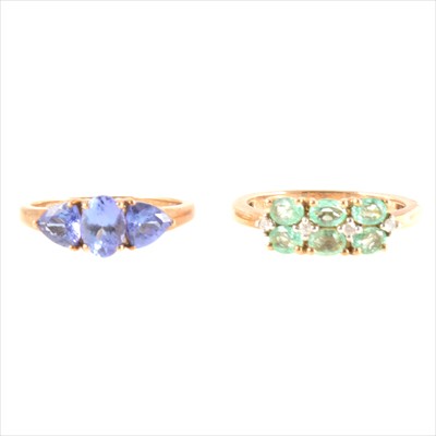 Lot 206 - A tanzanite three stone ring and a green six stone ring.